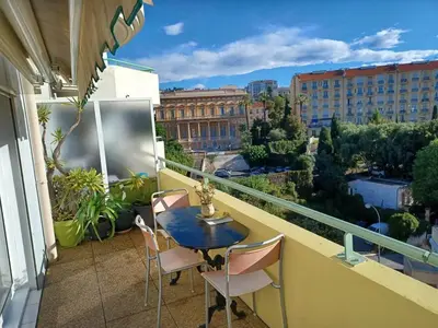 a balcony with a table and chairs on a balcony at L'escale à la French Riviera in Nice