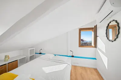 a white room with a bed and a window at Le Panoramique - Vieux-Nice in Nice