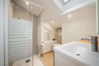 a white bathroom with a sink and a shower at Le Panoramique - Vieux-Nice in Nice