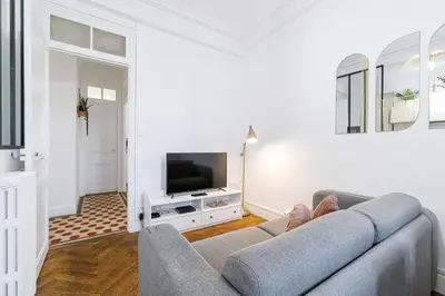 a living room with a couch and a tv at Large 2 Bdr City Center close to Train Station in Nice