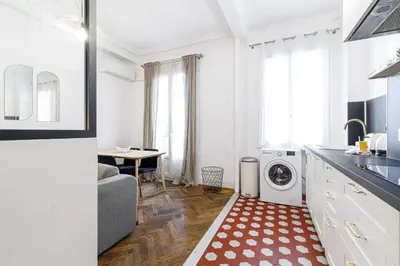 a kitchen with a washer and dryer in a room at Large 2 Bdr City Center close to Train Station in Nice