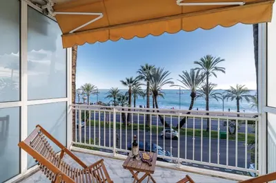a balcony with a view of the ocean and palm trees at PROM 92 - Amazing Sea View 3 rooms with terrace in Nice
