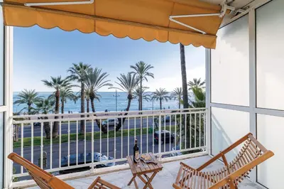 a balcony with a view of the ocean and palm trees at PROM 92 - Amazing Sea View 3 rooms with terrace in Nice
