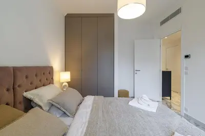 a bedroom with a large bed and a lamp at PROM 92 - Amazing Sea View 3 rooms with terrace in Nice