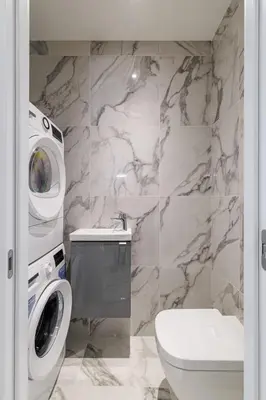 a bathroom with a toilet sink and a washing machine at PROM 92 - Amazing Sea View 3 rooms with terrace in Nice
