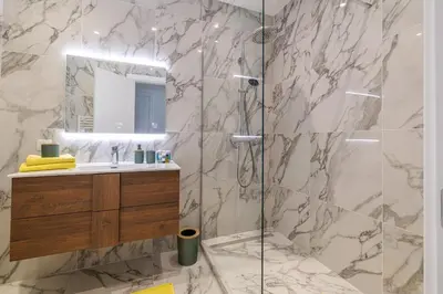a bathroom with a shower with a sink and a mirror at PROM 92 - Amazing Sea View 3 rooms with terrace in Nice