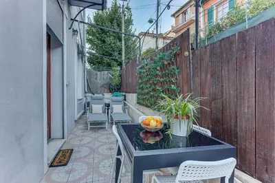 a small patio with a table with fruit on it at LE CYRNOS AP4499 By Riviera Holiday Homes in Nice