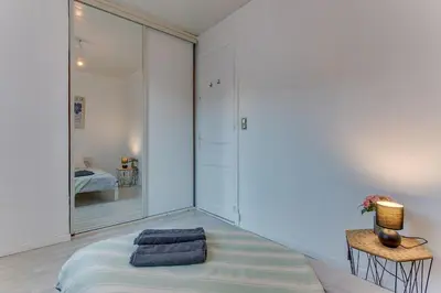 a bedroom with a bed and a table with a lamp at LE CYRNOS AP4499 By Riviera Holiday Homes in Nice