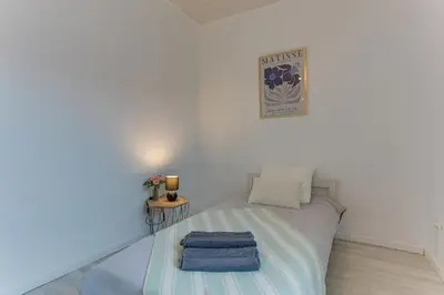 a small bedroom with a bed and a table at LE CYRNOS AP4499 By Riviera Holiday Homes in Nice