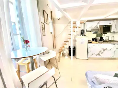 a living room with a table and a kitchen at Small Duplex - Downtown - Close to Beaches in Nice