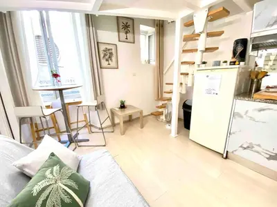 a living room with a couch and a kitchen at Small Duplex - Downtown - Close to Beaches in Nice