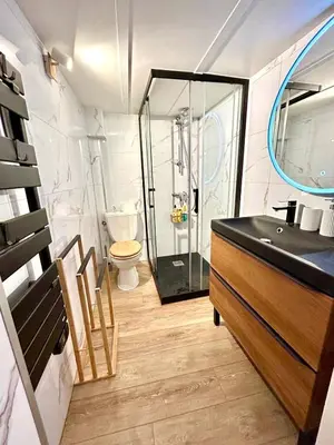 a bathroom with a glass shower and a sink at Small Duplex - Downtown - Close to Beaches in Nice