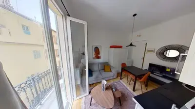 a living room with a couch and a table at Appartement Nice Libération in Nice