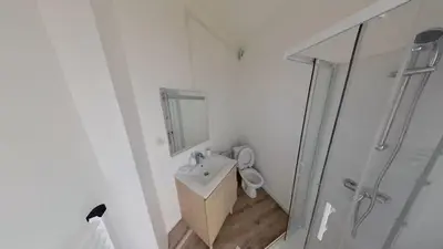 a white bathroom with a sink and a shower at Appartement Nice Libération in Nice