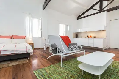 a bedroom with a bed and a table and chairs at loft proche port Nice in Nice