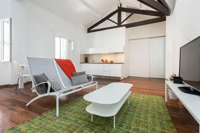 a living room with a couch and a table at loft proche port Nice in Nice