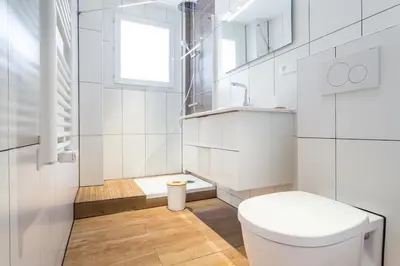 a white bathroom with a toilet and a window at loft proche port Nice in Nice