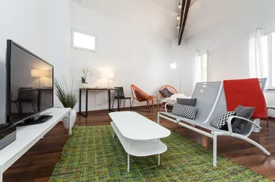 a living room with a couch and a tv at loft proche port Nice in Nice