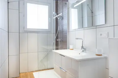 a white bathroom with a sink and a shower at loft proche port Nice in Nice