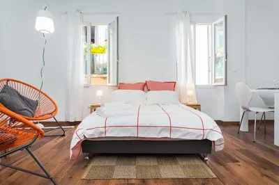 a bedroom with a bed and a table and chairs at loft proche port Nice in Nice