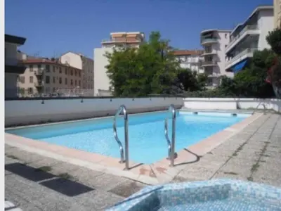 a large blue swimming pool in a city at Studio Libération Piscine centre ville Nice in Nice