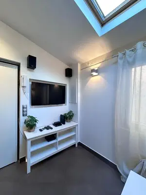 a living room with a flat screen tv on a wall at Midnight Blue - Heart of Nice - Breakfast - AC -Wi-Fi in Nice