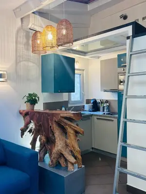 a kitchen with a wooden table and a ladder at Midnight Blue - Heart of Nice - Breakfast - AC -Wi-Fi in Nice