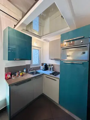 a kitchen with a blue refrigerator and a sink at Midnight Blue - Heart of Nice - Breakfast - AC -Wi-Fi in Nice