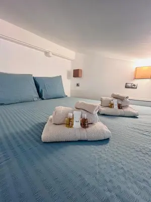 a bedroom with two beds with towels and candles on them at Midnight Blue - Heart of Nice - Breakfast - AC -Wi-Fi in Nice