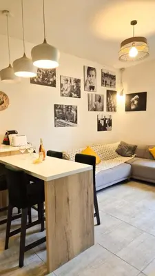 a living room with a table and a couch at Joli T3 moderne avec terrasse & climatisation in Nice