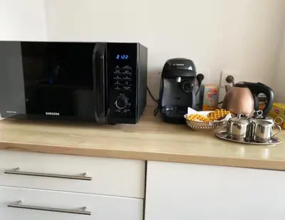 a microwave sitting on top of a kitchen counter at Vue Mer Panoramique - Terrasse - Climatisation - 2 Bedrooms - Wifi - Cuisine - Tramway in Nice
