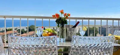 a table with fruits and vegetables on top of a balcony at Vue Mer Panoramique - Terrasse - Climatisation - 2 Bedrooms - Wifi - Cuisine - Tramway in Nice