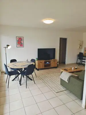 a living room with a couch and a table at Appartement lumineux avec terrasse à Nice in Nice