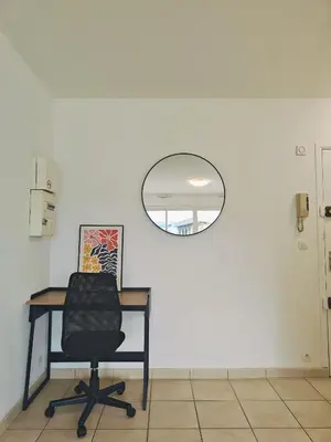 a living room with a couch and a table at Appartement lumineux avec terrasse à Nice in Nice