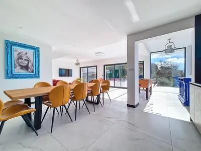 a dining room with a wooden table and chairs at Domaine Datcha - La Dolce Vita, en toute intimité in Aspremont
