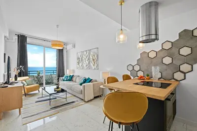 a kitchen and living room with a table and chairs at Baie des Anges in Nice