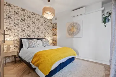 a bedroom with a bed with a yellow blanket at Baie des Anges in Nice
