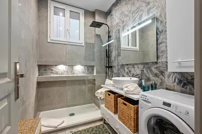 a bathroom with a washing machine and a sink at Baie des Anges in Nice