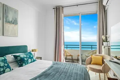 a bedroom with a bed and a view of the ocean at Baie des Anges in Nice