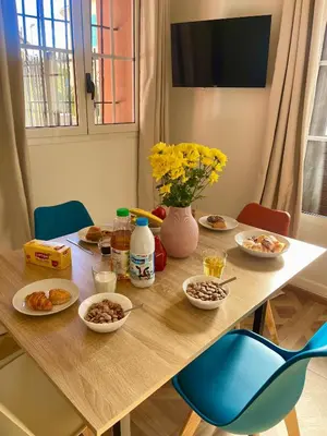 a wooden table with plates of food on it at Appartement Jasmin 2 pièces central à Cagnes-sur-Mer in Cagnes-sur-Mer