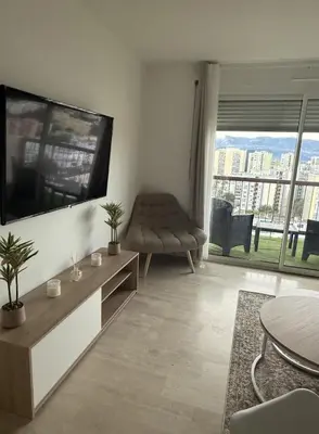 a living room with a large flat screen tv on a wall at Deux pièces moderne avec balcon & Vue dégagée in Nice
