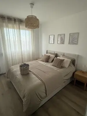a bedroom with a large bed with a basket on it at Deux pièces moderne avec balcon & Vue dégagée in Nice