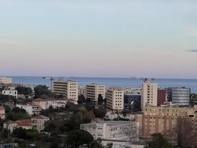 a city with buildings and the ocean in the background at Deux pièces moderne avec balcon & Vue dégagée in Nice