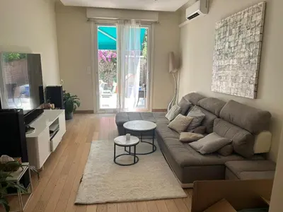 a living room with a couch and a table at Elegant apartment in Nice with a private garden in Nice
