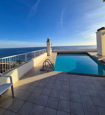 a swimming pool on a balcony with a view of the ocean at Royal Luxembourg Nice Prom' in Nice
