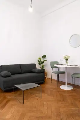 a living room with a couch and chairs and a table at Appartement en plein centre-ville in Nice