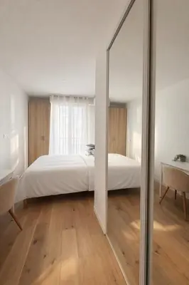 a bedroom with a bed and a large mirror at Luxury Beachfront 2BR Promenade des Anglais in Nice