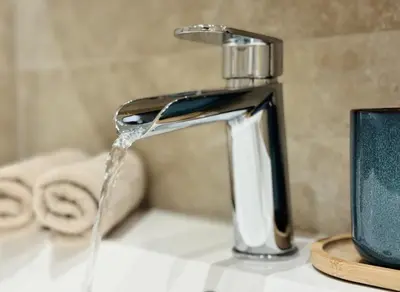 a sink with water coming out of a faucet at Luxury Beachfront 2BR Promenade des Anglais in Nice