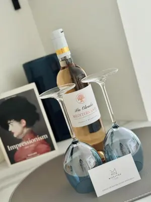 a bottle of wine and two glasses on a table at Luxury Beachfront 2BR Promenade des Anglais in Nice