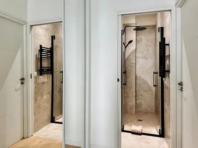 a bathroom with a shower and a glass door at Luxury Beachfront 2BR Promenade des Anglais in Nice